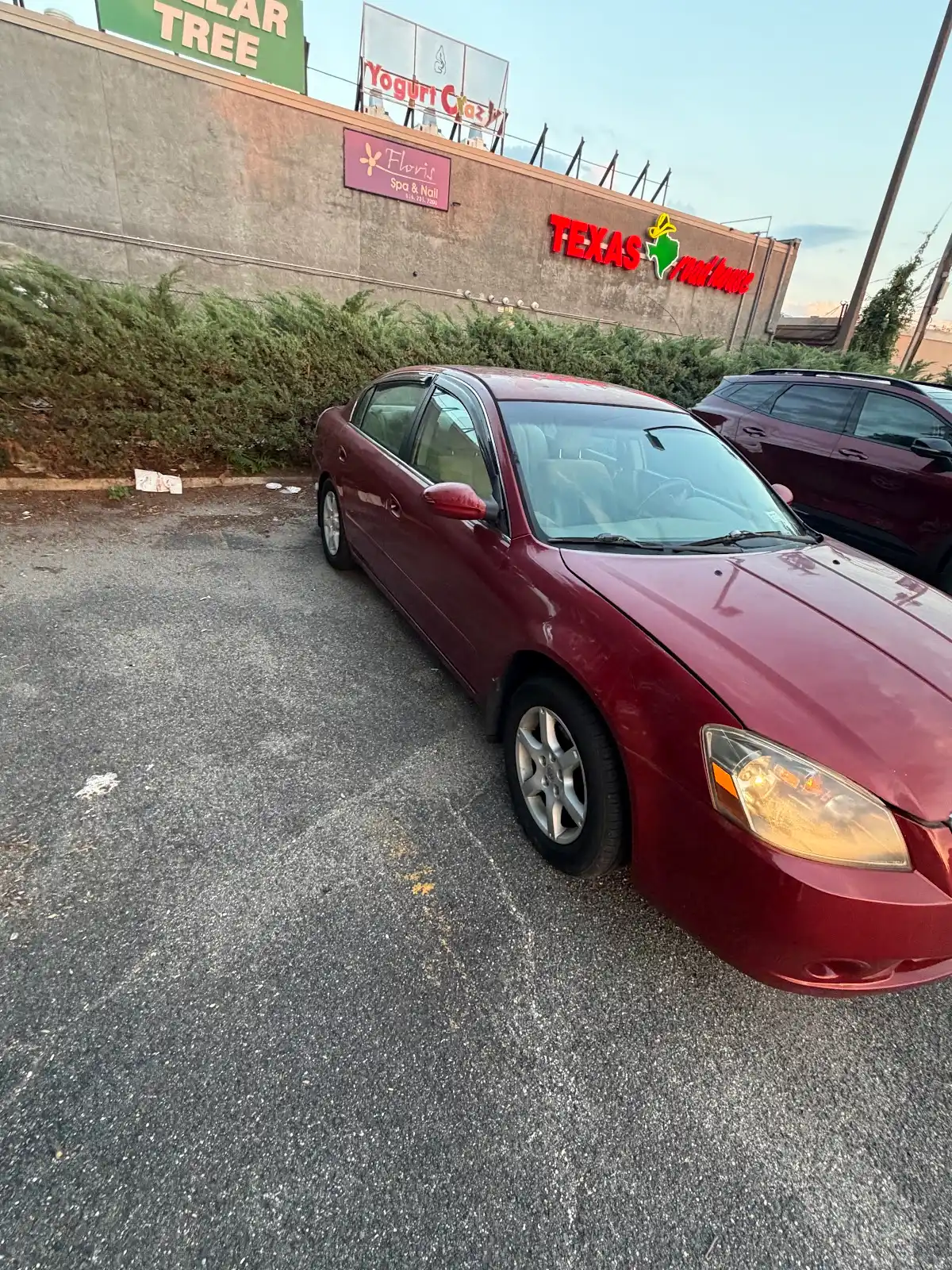 Front passenger-side view of the red Nissan Altima