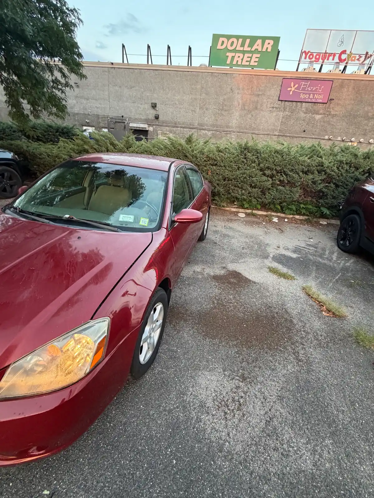 Front driver-side view of the red Nissan Altima
