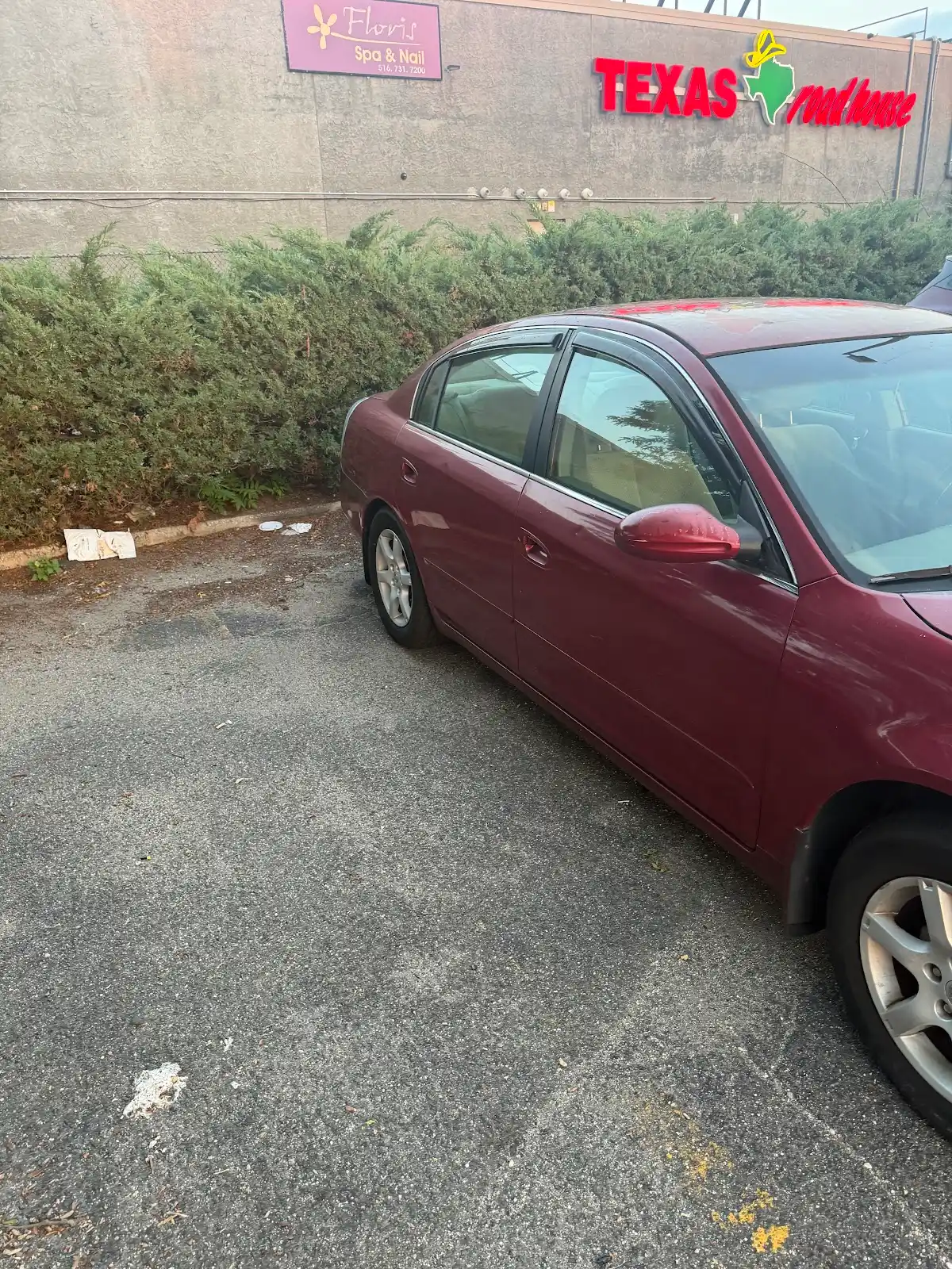 Passenger-side view of the red Nissan Altima